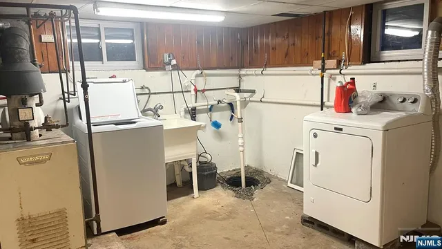 a kitchen with a sink a refrigerator and cabinets