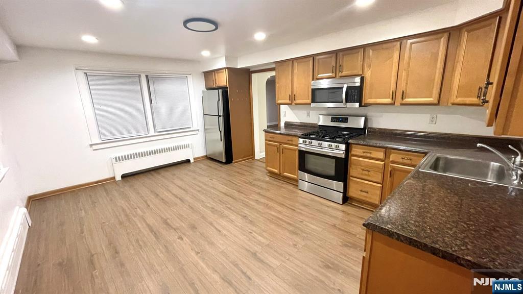 47-49 Fairview Avenue, Unit A Closter, NJ 07624 - Photo 5 of 19 a kitchen with stainless steel appliances granite countertop a refrigerator a sink dishwasher a stove and white countertops with wooden floor