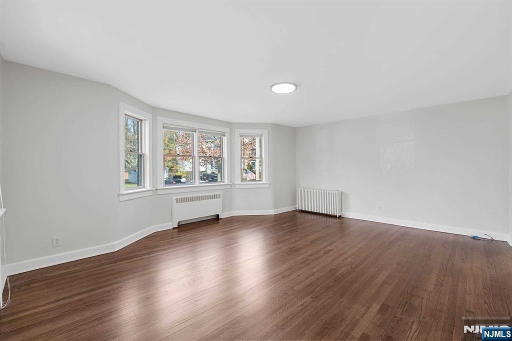 47-49 Fairview Avenue, Unit A Closter, NJ 07624 - Photo 10 of 19 a view of an empty room with wooden floor and a window