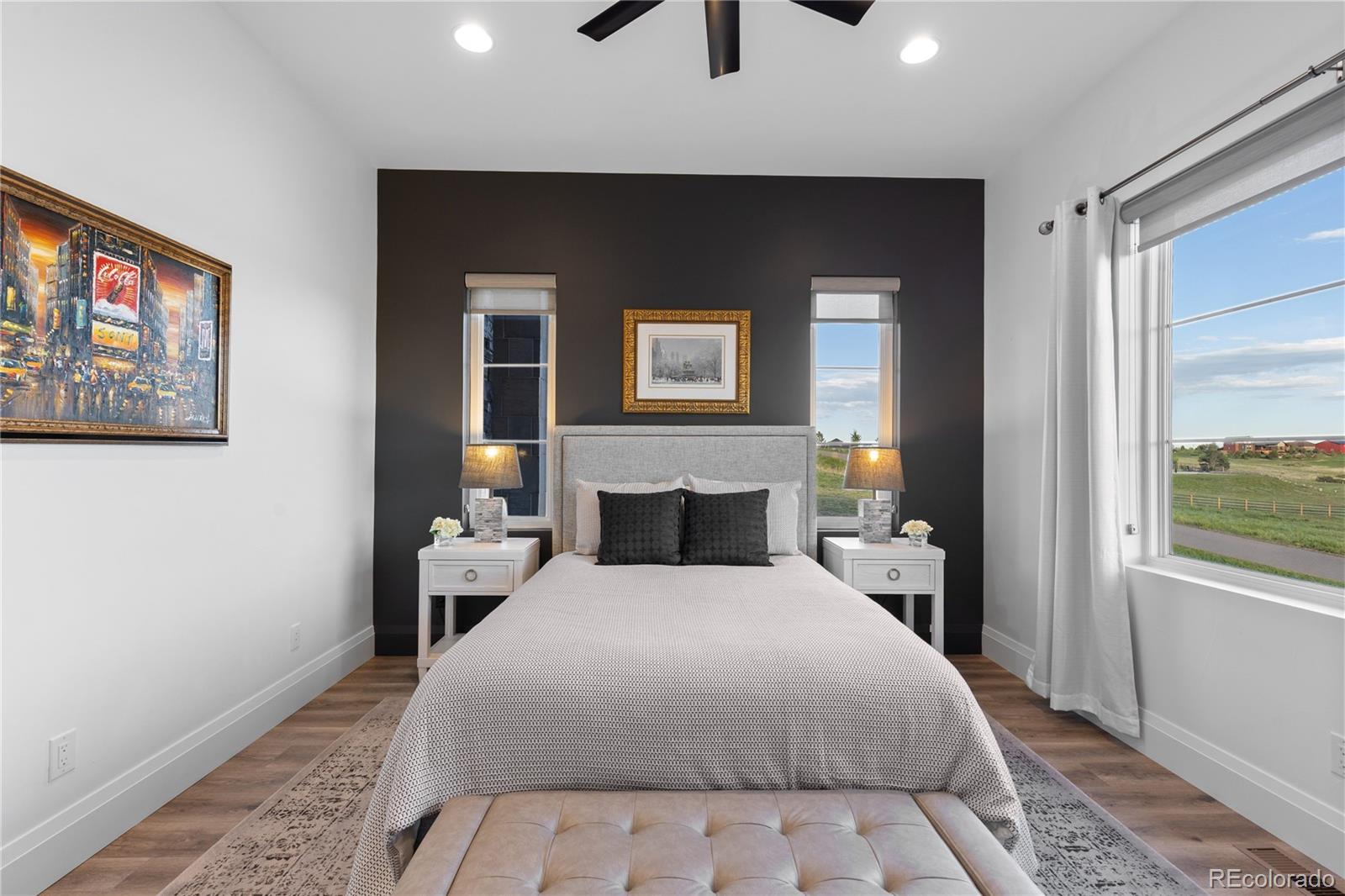 10689 Shadow Pines Road Parker, CO 80138 - Photo 18 of 50 a bedroom with a large bed and a tv