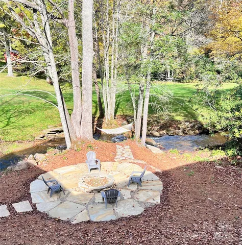 a view of a backyard with sitting area