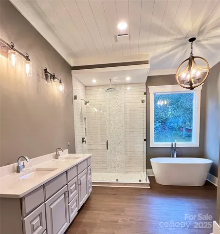 a bathroom with a large tub and a large window