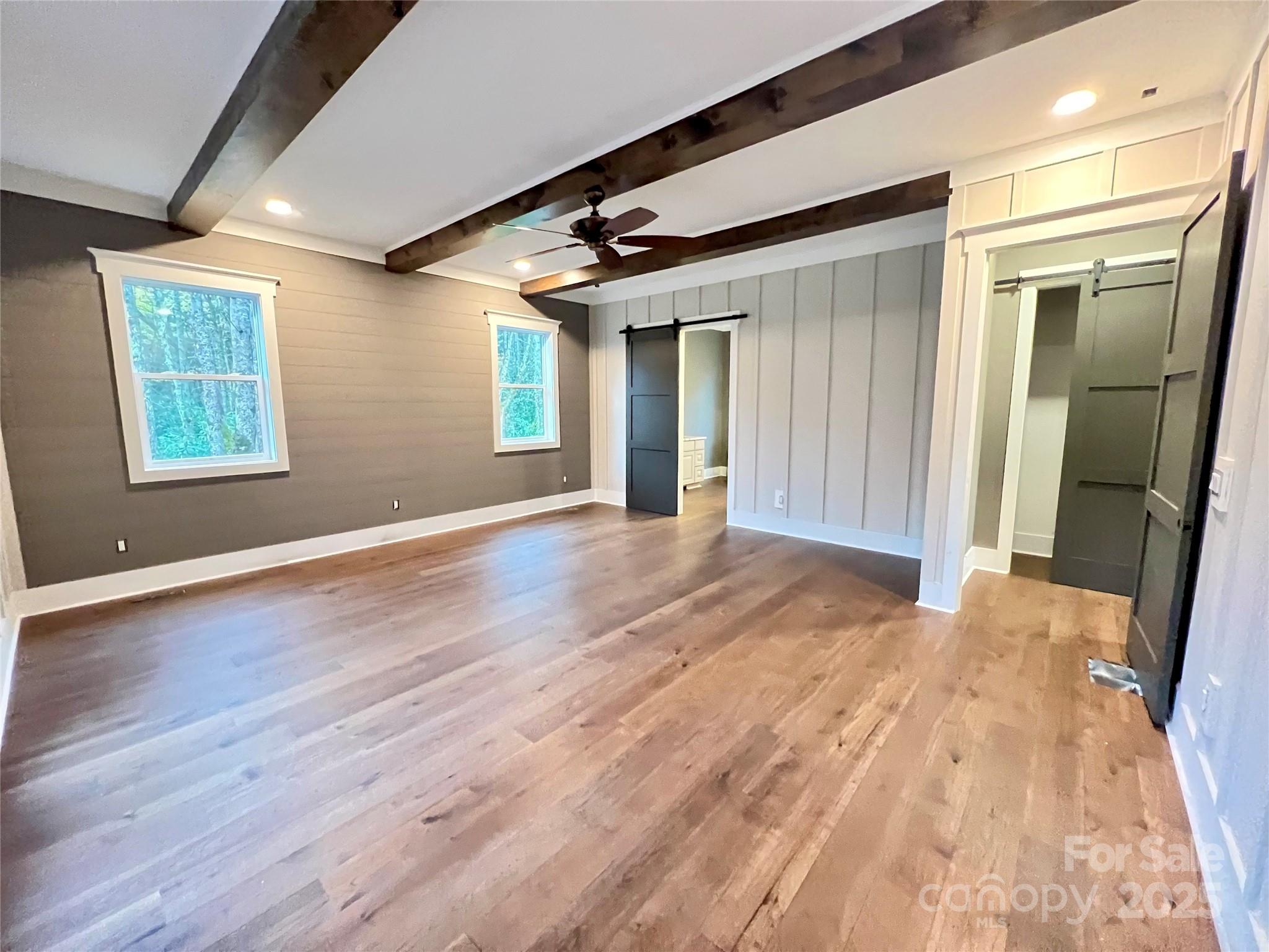 159 Comanche Road Cullowhee, NC 28723 - Photo 21 of 34 en empty room with wooden floor and windows