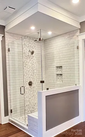 a view of a livingroom with wooden floor and a ceiling fan