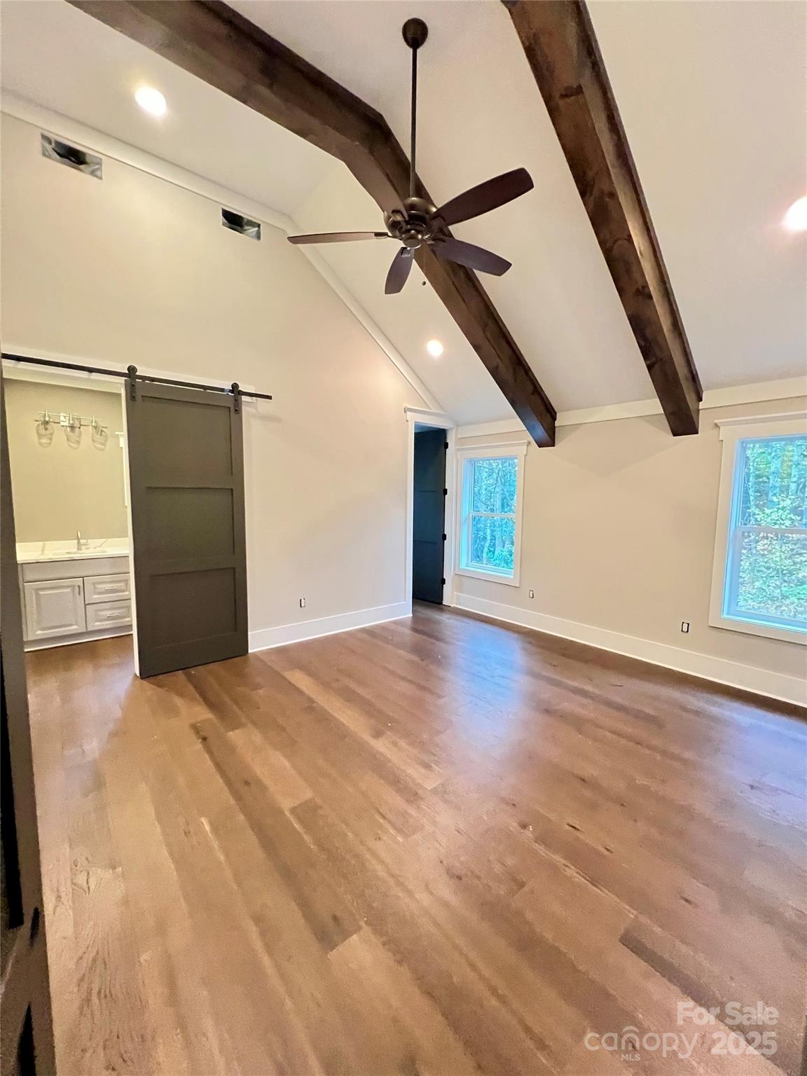 159 Comanche Road Cullowhee, NC 28723 - Photo 27 of 34 a view of a livingroom with wooden floor and a ceiling fan