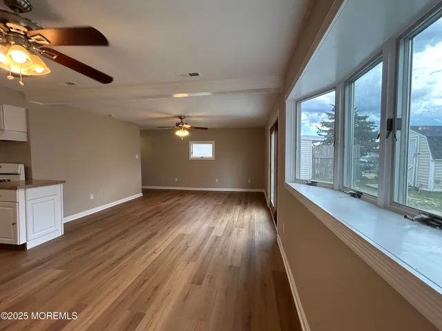 a bathroom with a sink a toilet a mirror and shower