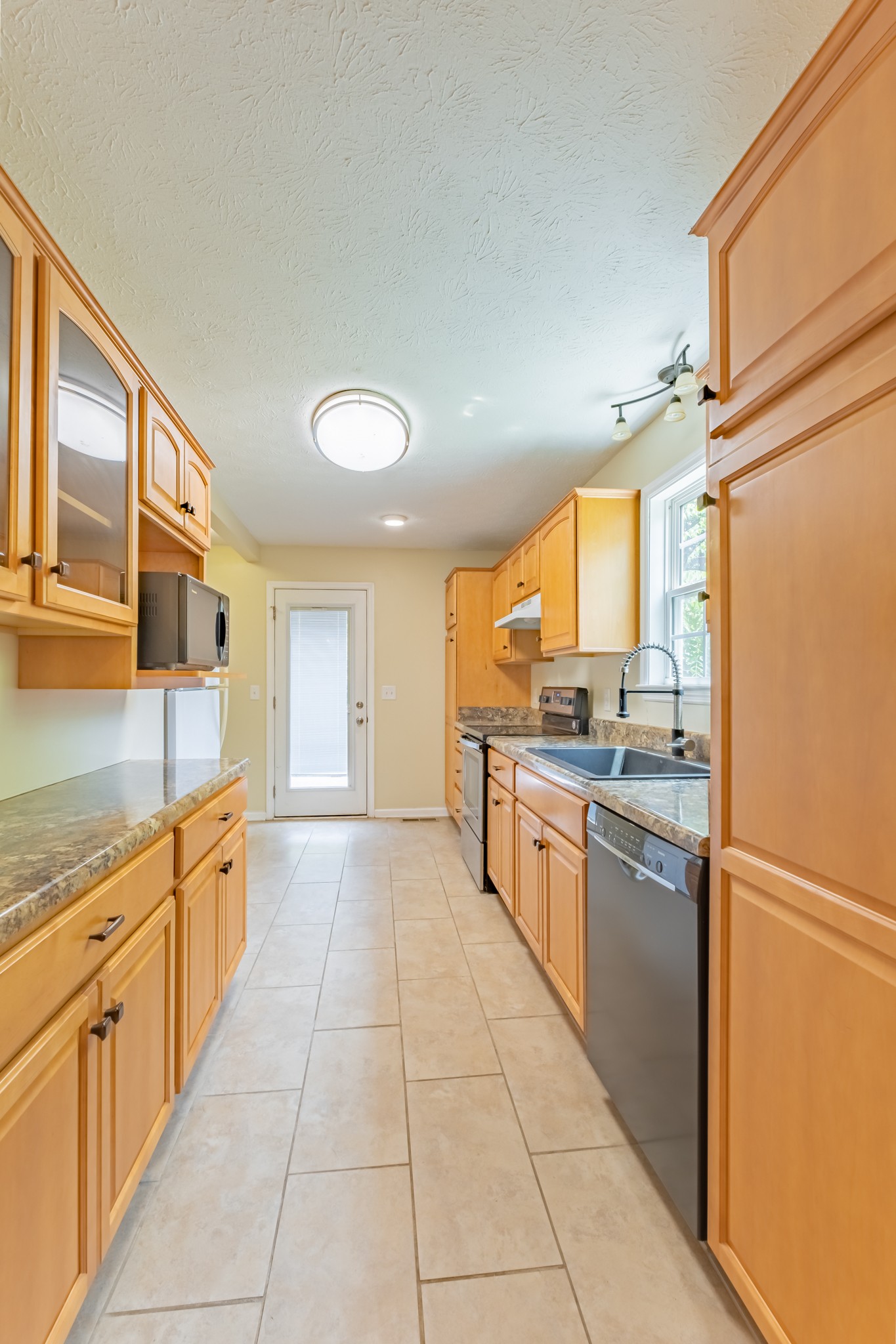 181 Bonnafield Drive Hermitage, TN 37076 - Photo 21 of 44 a large kitchen with stainless steel appliances granite countertop a refrigerator and a stove top oven