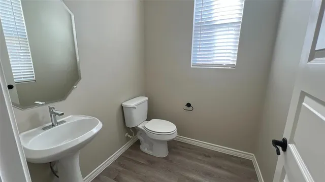 a bathroom with a sink toilet and a mirror