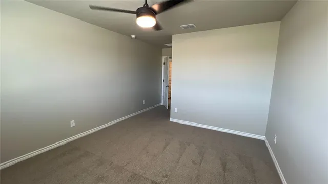 an empty room with a empty space and a ceiling fan