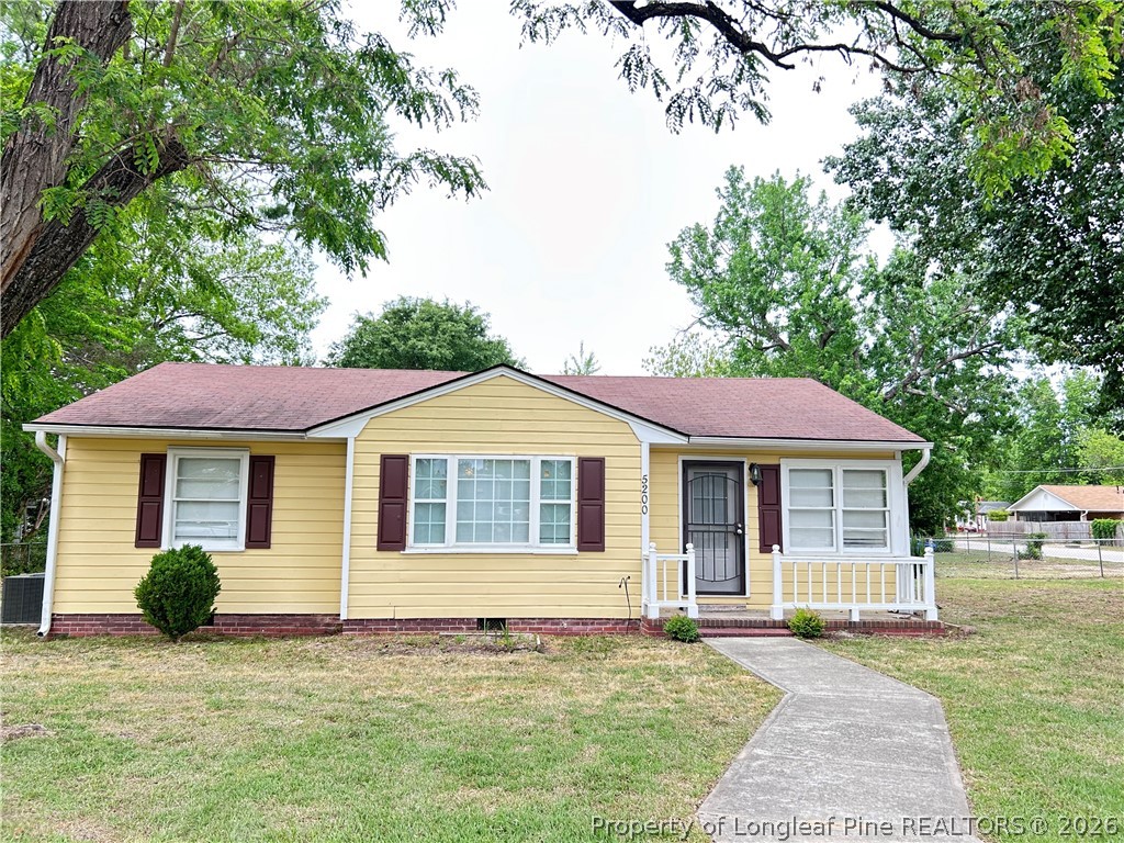 a house that has a tree in front of the house