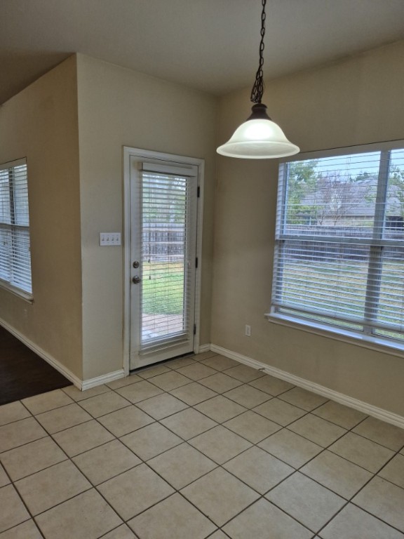 808 Busleigh Castle Way Pflugerville, TX 78660 - Photo 12 of 30 a room with a chandelier and a large window