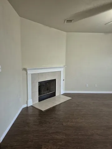 a view of empty room with a fireplace