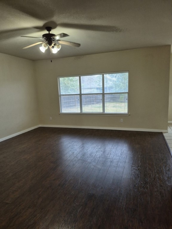 808 Busleigh Castle Way Pflugerville, TX 78660 - Photo 14 of 30 an empty room with wooden floor and windows