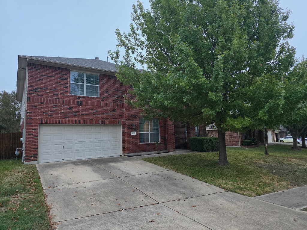 808 Busleigh Castle Way Pflugerville, TX 78660 - Photo 2 of 30 a front view of a house with a garden and trees