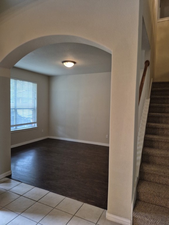 808 Busleigh Castle Way Pflugerville, TX 78660 - Photo 4 of 30 an empty room with wooden floor and windows