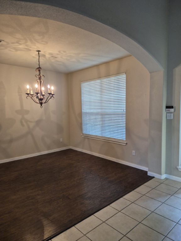808 Busleigh Castle Way Pflugerville, TX 78660 - Photo 5 of 30 a view of empty room with wooden floor and chandelier