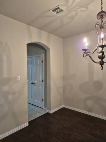 a view of a room with wooden floor