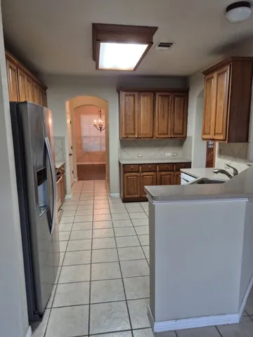 a kitchen with stainless steel appliances a refrigerator and a stove