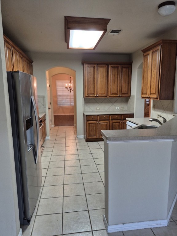 808 Busleigh Castle Way Pflugerville, TX 78660 - Photo 8 of 30 a kitchen with stainless steel appliances a refrigerator and a stove