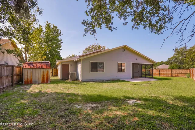 a front view of house with yard and trees
