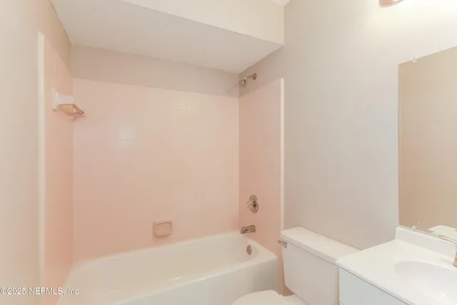 a bathroom with a bathtub and a sink
