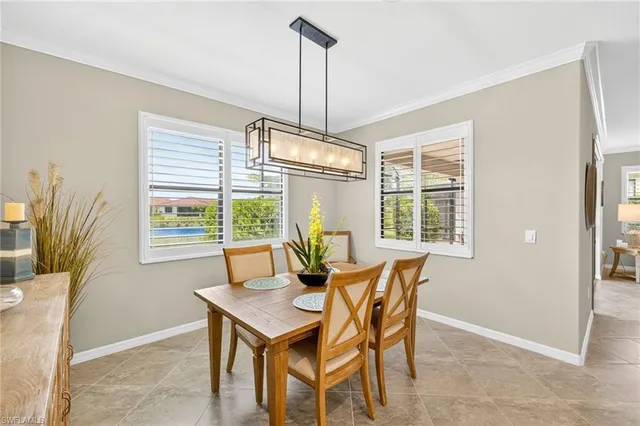 a dining room with furniture a chandelier and wooden floor