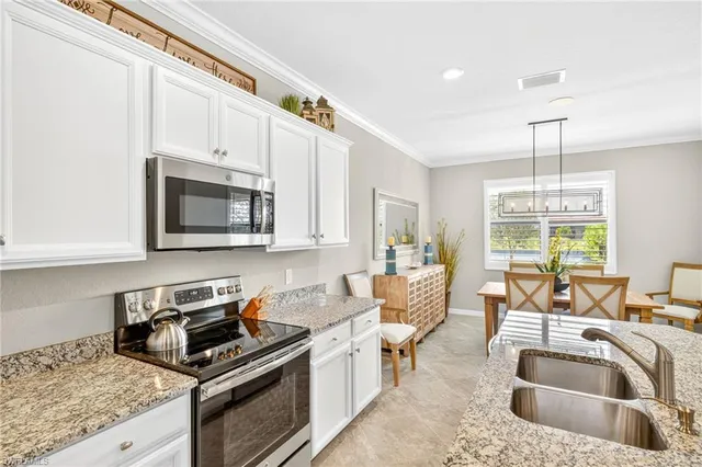 a kitchen with a stove a sink and a microwave