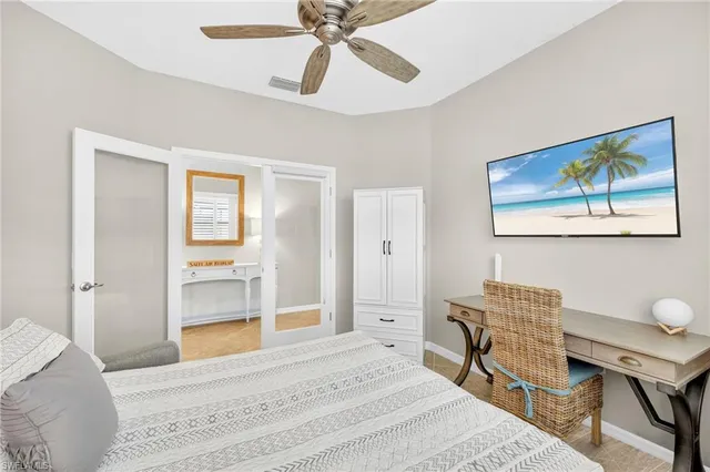 a bedroom with a bed and a chandelier