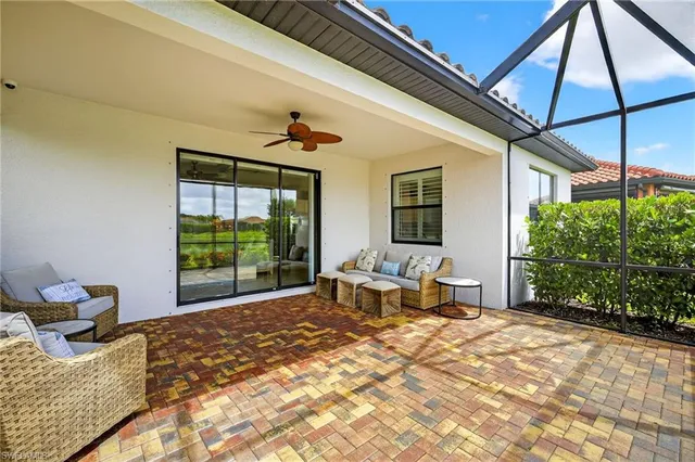 a bedroom with a bed and large windows