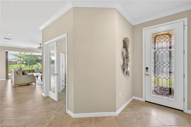 a view of an entryway with wooden floor and a livingroom view