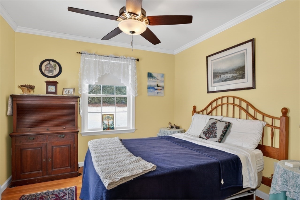 37 Tower Street Hudson, MA 01749 - Photo 14 of 35 a bedroom with a bed and wooden floor