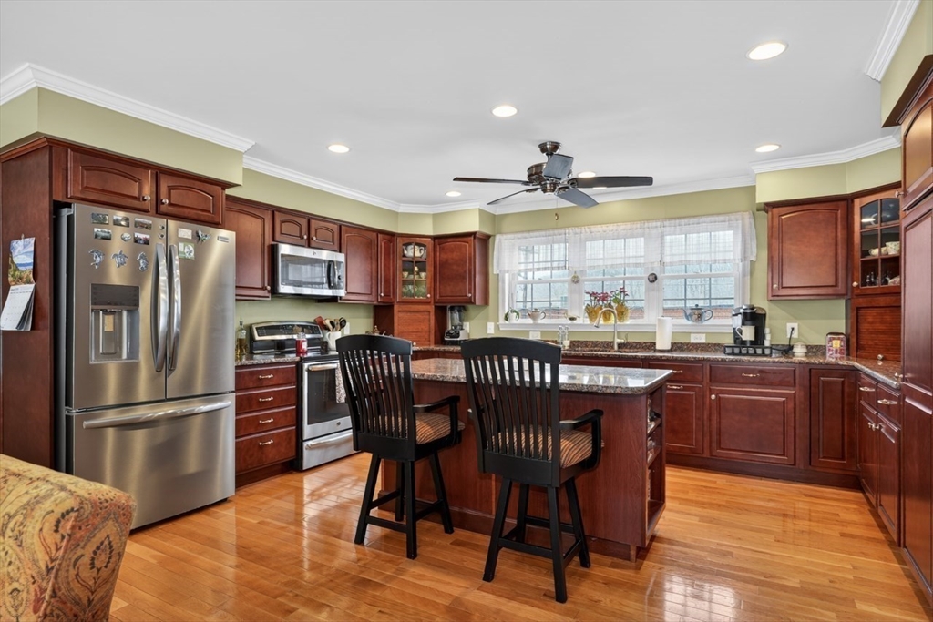 37 Tower Street Hudson, MA 01749 - Photo 4 of 35 a kitchen with stainless steel appliances granite countertop a refrigerator a stove a sink a dining table and chairs