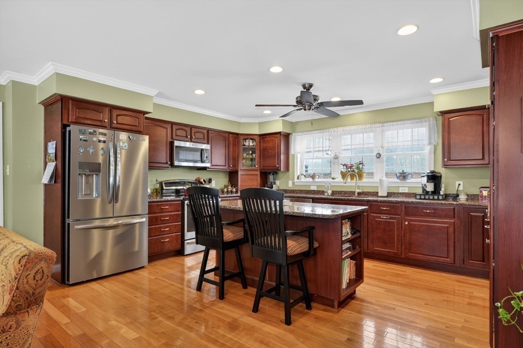 37 Tower Street Hudson, MA 01749 - Photo 5 of 35 a kitchen with stainless steel appliances granite countertop a refrigerator a stove a sink a dining table and chairs