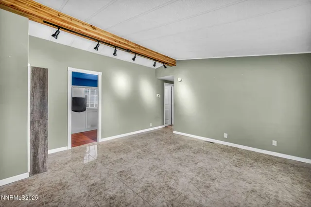 a kitchen with a refrigerator and white cabinets
