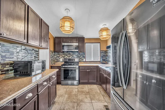 a kitchen with stainless steel appliances granite countertop a stove and a sink