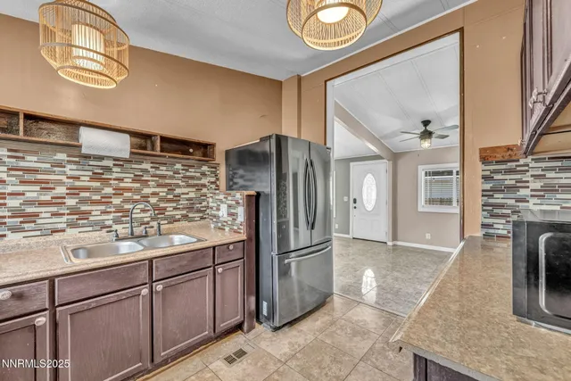 a kitchen with stainless steel appliances granite countertop a refrigerator and a stove top oven