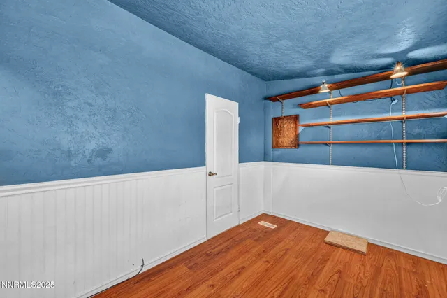 a view of room with window and wooden floor