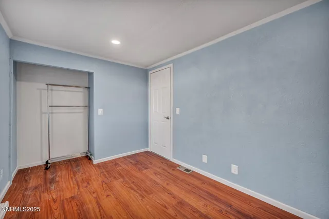 a view of a house with a backyard and basketball court