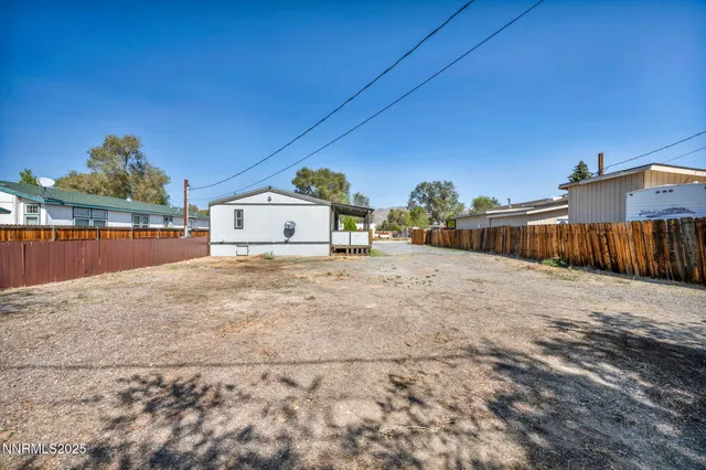 a view of a house with wooden fence