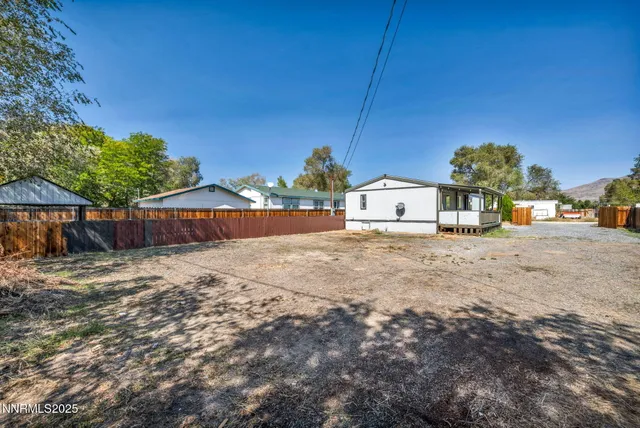 a view of a house with wooden fence