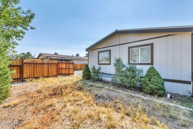 a view of a backyard with large trees