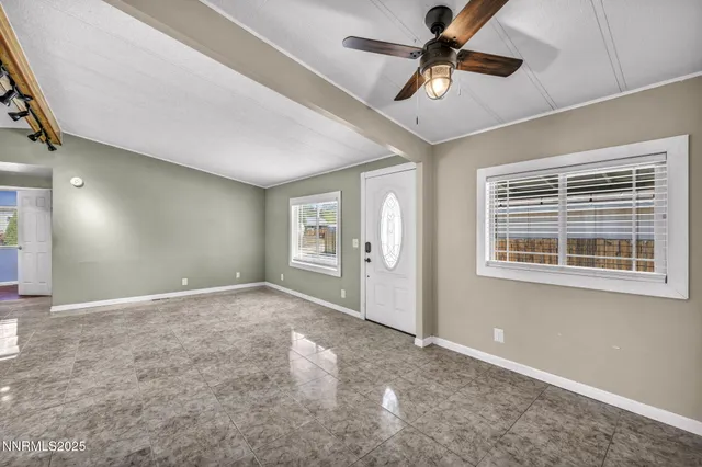 a view of a livingroom with a ceiling fan and window