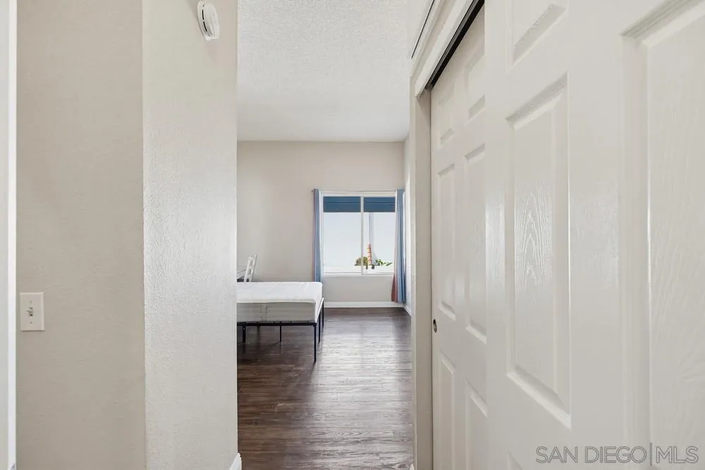 8324 Regents Road, Unit 2E San Diego, CA 92122 - Photo 16 of 31 a view of a hallway with wooden floor and a bathroom