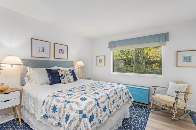 a bedroom with a bed and a large window