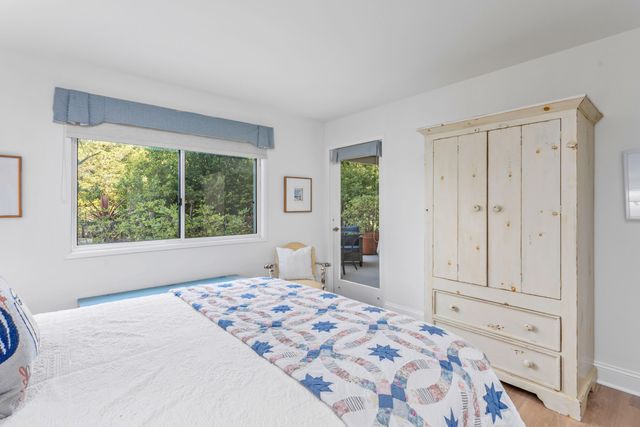 a bedroom with a large bed and a window