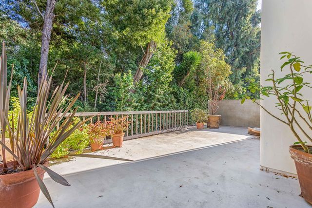 a balcony with trees in front of it