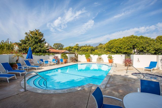 a view of a swimming pool with an outdoor seating