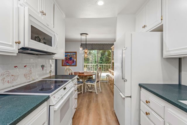 a kitchen with stainless steel appliances a stove a sink and a microwave