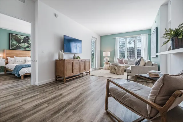 a living room with furniture and a large window