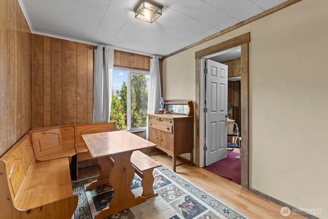 a table and chairs in a room next to a window